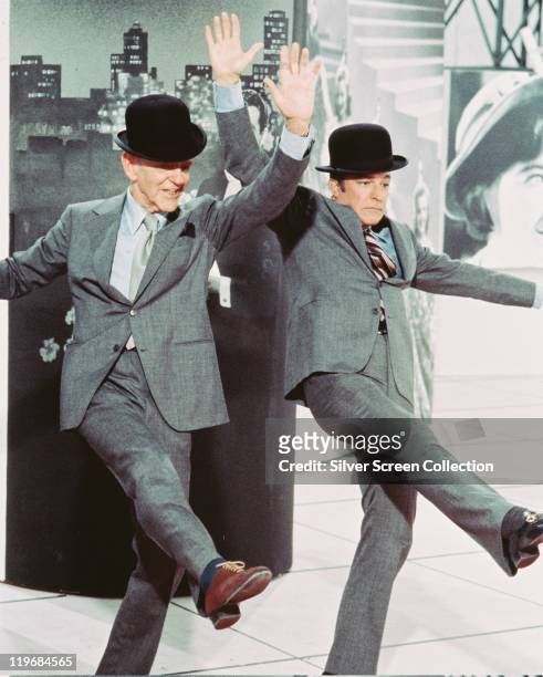 Fred Astaire , US actor and dancer, and Gene Kelly , US actor and dancer, both dancing and dressed in grey suits and bowler hats, in a publicity...