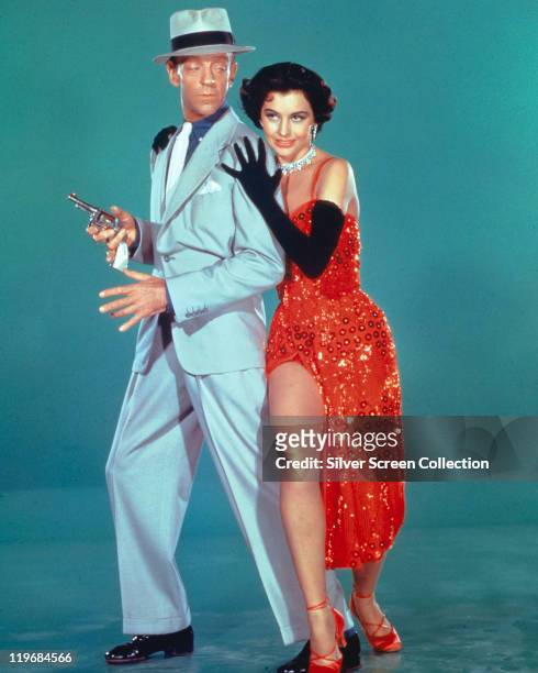 Fred Astaire , US actor and dancer, wearing a light blue suit and fedora, with a black band, and Cyd Charisse , US actress and dancer, wearing a red...