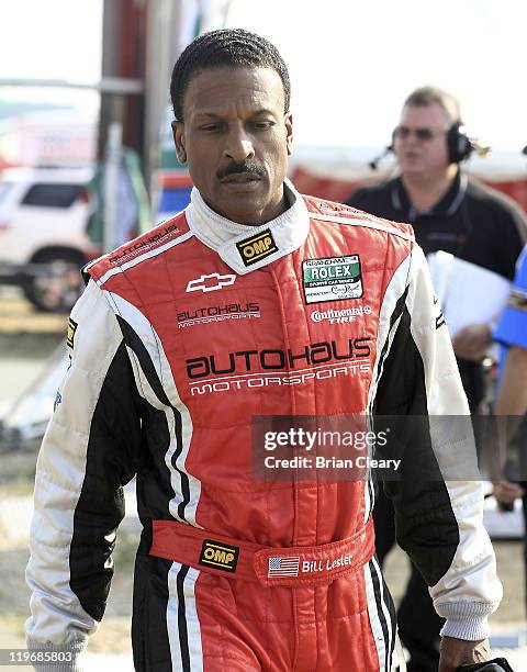 Bill Lester walks through the paddock after qualifying for the American Red Cross 250 Grand-Am Rolex Series race at New Jersey Motorsports Park on...