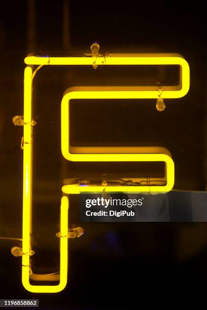 yellow neon single letter 'f' - f stock pictures, royalty-free photos & images