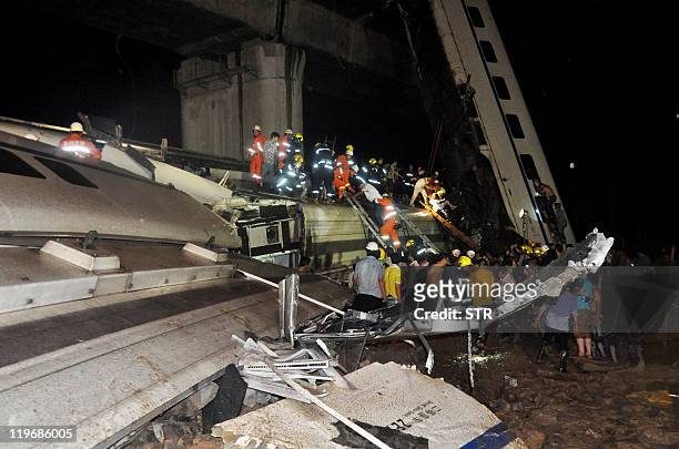 Firefighters search for survivors in the wreckage of a high-speed train which derailed between the cities of Hangzhou and Wenzhou, in eastern China's...