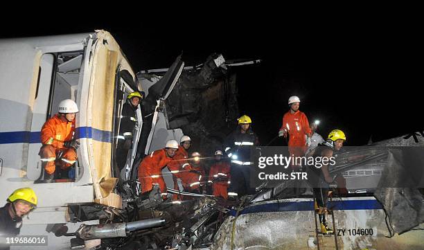 Firefighters search for survivors in the wreckage of a high-speed train which derailed between the cities of Hangzhou and Wenzhou, in eastern China's...