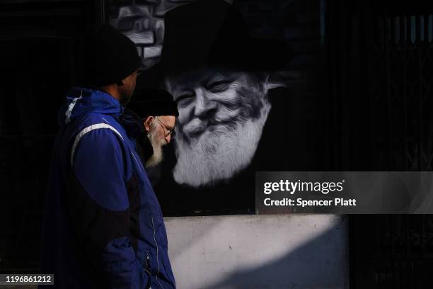 People walk through the Orthodox Jewish section of the Crown Heights neighborhood in Brooklyn on December 31, 2019 in New York City. Five Orthodox...