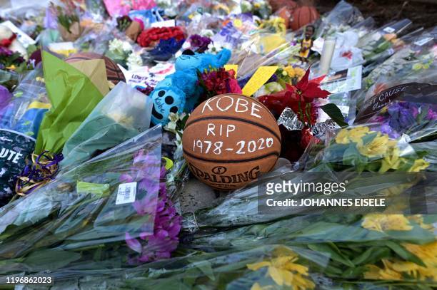 Basketballs are seen outside Bryant Gymnasium at Lower Merion High School, where basketball legend Kobe Bryant formally attended school, after his...