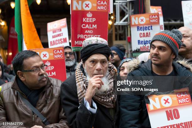 Protesters hold placards during the demonstration. People gather outside the Indian High Commission in support of minorities that are discriminated...