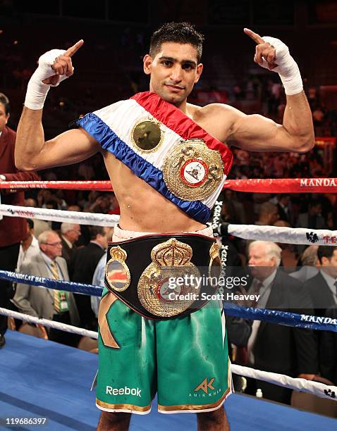 Amir Khan poses after his fifth round knockout of Zab Judah in their super lightweight world championship unification bout at Mandalay Bay Events...