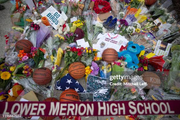 Flowers and other items are left at a memorial for former Los Angeles Laker Kobe Bryant after he was killed in a helicopter crash, at Lower Merion...