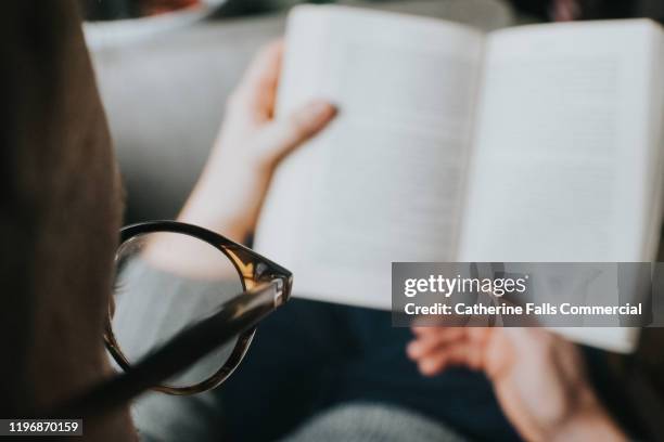 man reading a book - book worm stock pictures, royalty-free photos & images