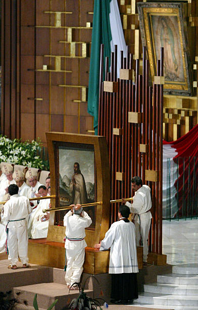 Painting depicting Juan Diego is put into place after Pope John Paul II canonized him during a Mass July 31, 2002 at the Basilica of Guadalupe in...