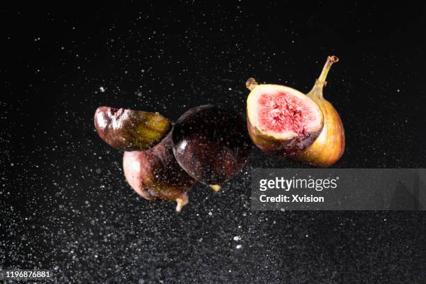 ficus carica l. flying in mid air captured with high speed sync. - fig ストックフォトと画像