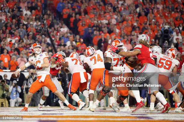 Quarterback Trevor Lawrence of the Clemson Tigers drops back to pass during the PlayStation Fiesta Bowl against the Ohio State Buckeyes at State Farm...