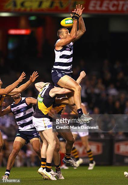 James Podsiadly of the Cats flies for a mark during the round 18 AFL match between the Geelong Cats and the Richmond Tigers at Etihad Stadium on July...