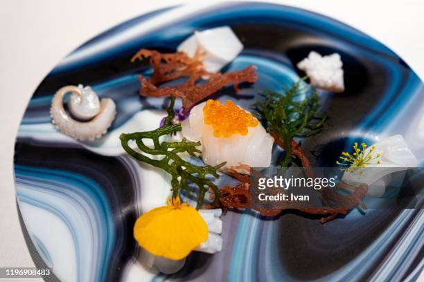 luxury fine dining, french food, calamari and squid sashimi with orange caviar - karatsu saga stock pictures, royalty-free photos & images