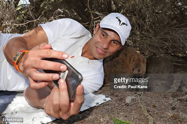 Rafael Nadal of Spain takes a selfie with a Quokka during a visit to Rottnest Island ahead of the 2020 ATP Cup Group Stage at RAC Arena on January...