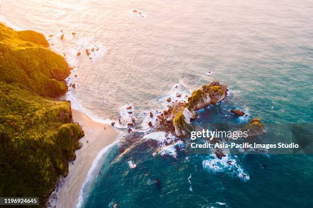 aerial view of surfers on the surfboards at sunset. - north island new zealand stock pictures, royalty-free photos & images