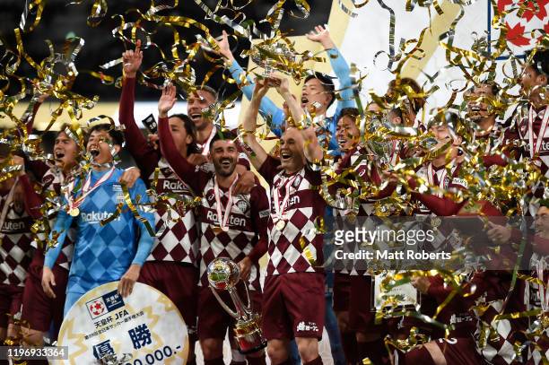 Andres Iniesta holds the trophy aloft during the trophy presentation of the 99th Emperor's Cup final between Vissel Kobe and Kashima Antlers at the...