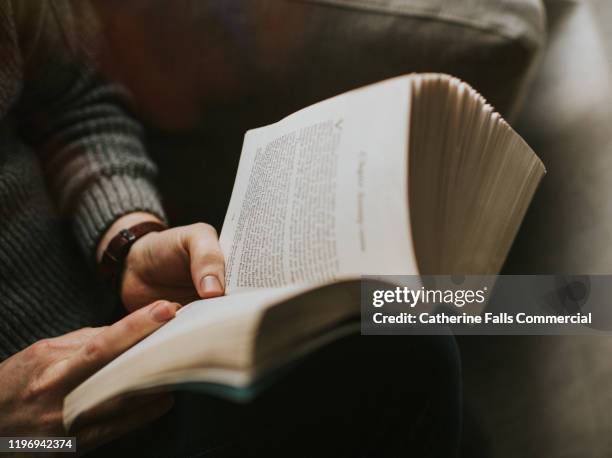 man reading a book - authors night fotografías e imágenes de stock