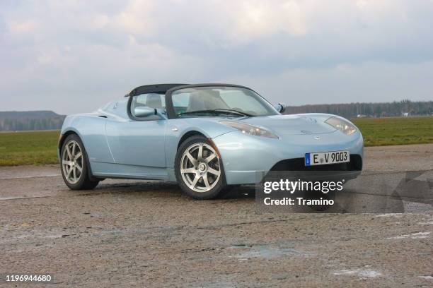 tesla roadster stopped on a road - sports roadster stock pictures, royalty-free photos & images