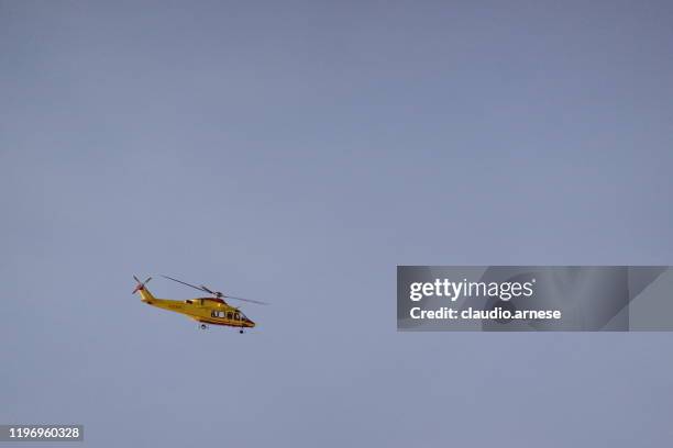 rescue helicopter during a mountain rescue - air ambulance stock pictures, royalty-free photos & images