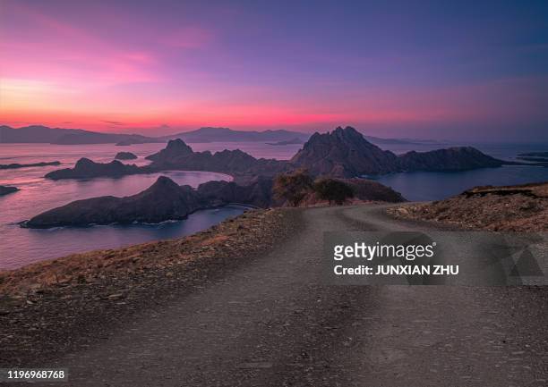 dirt road to the beautiful scenery of island padar of indonesia - komodo island stock pictures, royalty-free photos & images