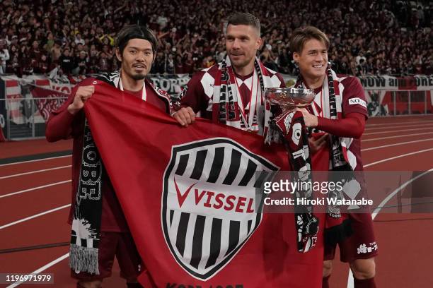 Hotaru Yamaguchi and Lukas Podolski and Gotoku Sakai of Vissel Kobe celebrate with the trophy after the 99th Emperor's Cup final between Vissel Kobe...
