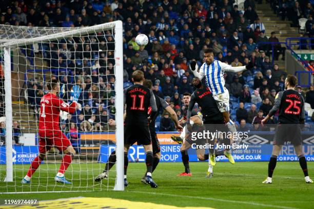 Steve Mounie of Huddersfield Town rises to score during the Sky Bet Championship match between Huddersfield Town and Stoke City at John Smith's...
