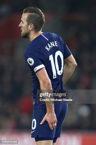 Harry Kane of Tottenham Hotspur holds his leg as he walks off the pitch to be substituted during the Premier League match between Southampton FC and...