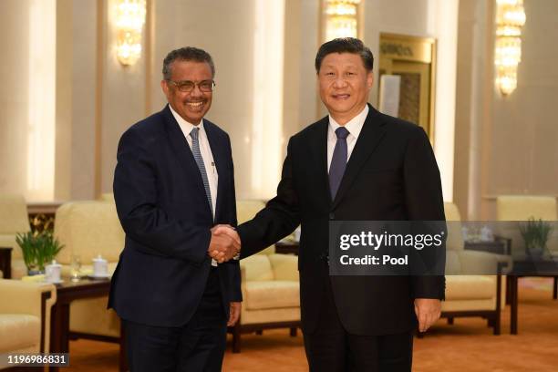 Tedros Adhanom, Director General of the World Health Organization, shakes hands with Chinese President Xi Jinping before a meeting at the Great Hall...