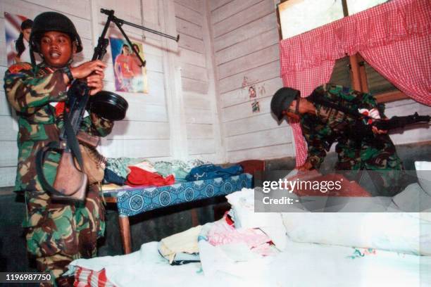 Two Indonesian marines raid a house which they believed belong to a Free Aceh Movement rebel at a village in Bireun, North Aceh 23 May 2003....