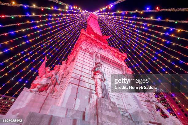 christmas in indianapolis - christmas tree on soldiers and sailors monumen - indianapolis sunset stock pictures, royalty-free photos & images