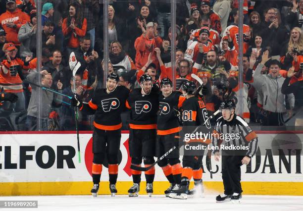 Kevin Hayes of the Philadelphia Flyers celebrates his third period goal, his second of the game against the New York Rangers, with teammates James...