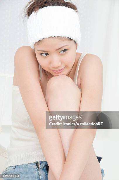 young woman - hugging knees stock pictures, royalty-free photos & images