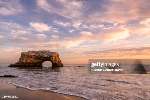 sunset view of natural bridges rock formation - california coastline stock pictures, royalty-free photos & images