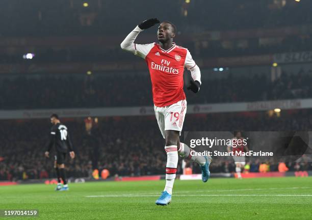 Nicolas Pepe celebrates scoring the 1st Arsenal goal during the Premier League match between Arsenal FC and Manchester United at Emirates Stadium on...