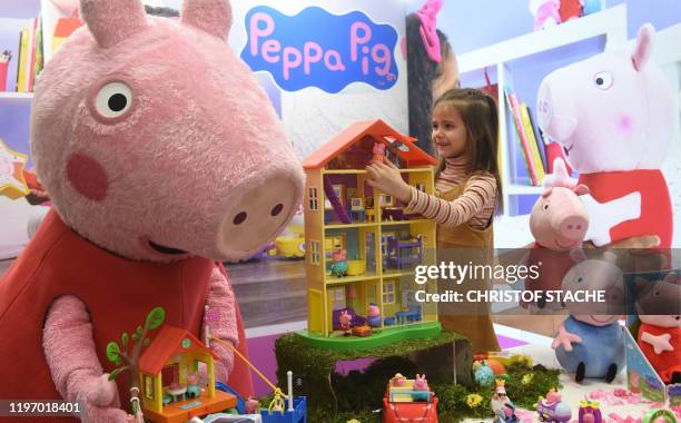 Young girl Daria plays with Peppa Pig toys at the booth of Jazwares company during the press preview of the international toys fair Spielwarenmesse...