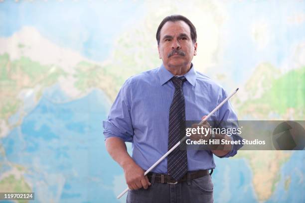 hispanic businessman standing near map with pointer - pointer stick stock pictures, royalty-free photos & images