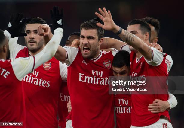 Sokratis Papastathopoulos of Arsenal celebrates his goal with Granit Xhaka and Sead Kolainac during the Premier League match between Arsenal FC and...