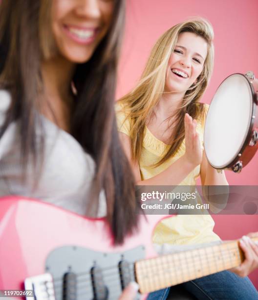 teenage girls playing guitar and tambourine - tambourine 個照片及圖片檔