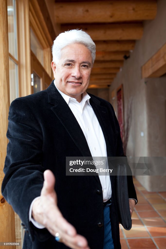 Hispanic businessman holding out hand