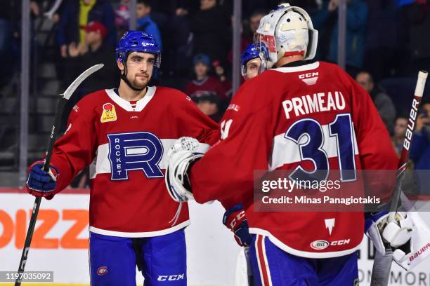Josh Brook of the Laval Rocket and goaltender Cayden Primeau celebrate a victory against the Toronto Marlies at Place Bell on December 28, 2019 in...
