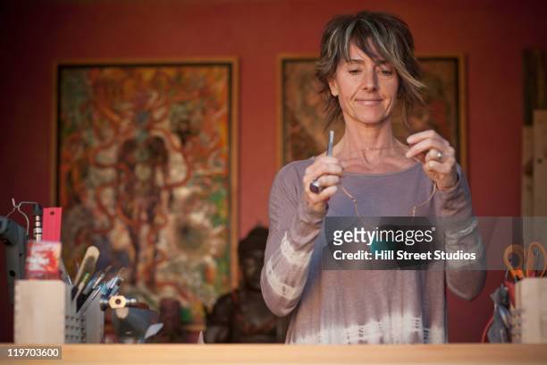 caucasian woman making jewelry - jewelry maker stock pictures, royalty-free photos & images