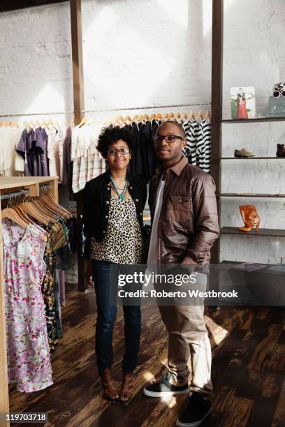 couple standing together in clothing store - small business saturday stock pictures, royalty-free photos & images