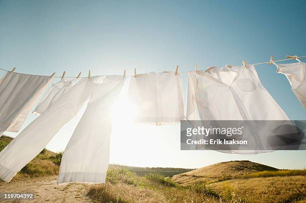 usa, california, ladera ranch, laundry hanging on clothesline against blue sky - clothesline imagens e fotografias de stock