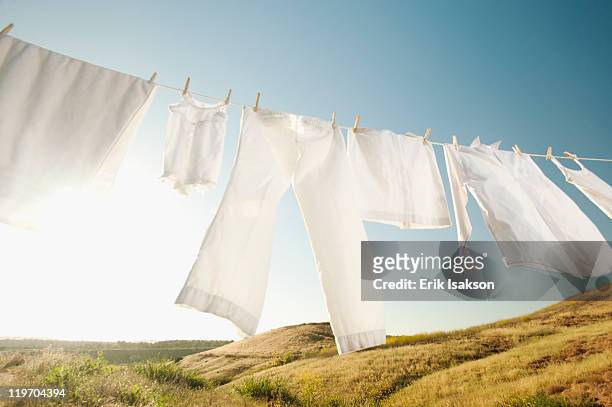usa, california, ladera ranch, laundry hanging on clothesline against blue sky - white laundry stock-fotos und bilder