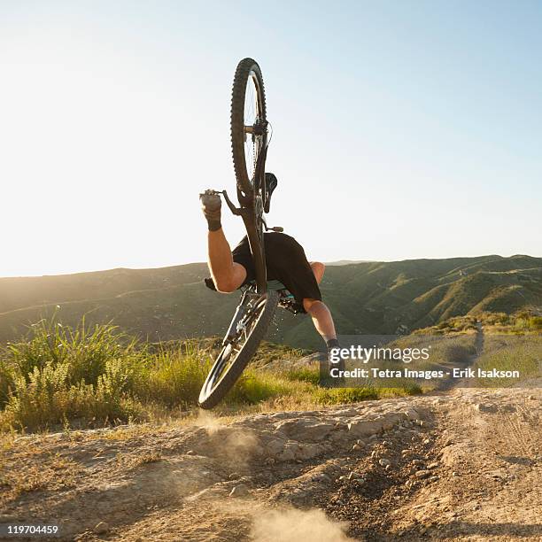 usa, california, laguna beach, mountain biker falling of his bike - falling on bike stock pictures, royalty-free photos & images