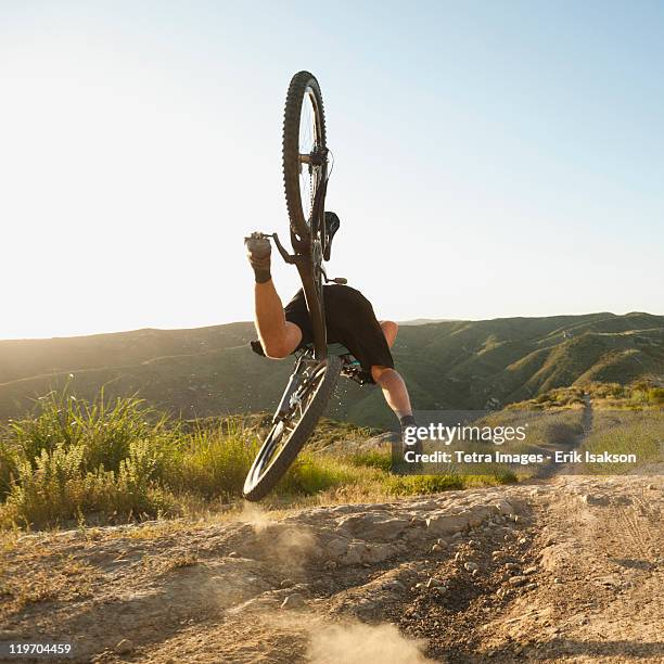 usa, california, laguna beach, mountain biker falling of his bike - drops back stock pictures, royalty-free photos & images