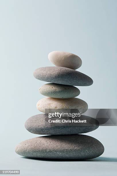 studio shot of rocks balancing on one another - zen stone stock pictures, royalty-free photos & images