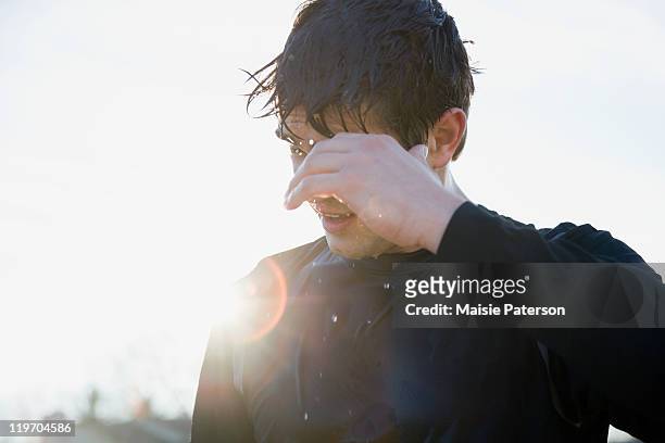 usa, michigan, man in sports clothing back lit by sun - heat exhaustion stock pictures, royalty-free photos & images