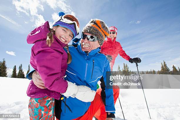 usa, colorado, telluride, grandparents with girl (10-11) posing during ski holiday - grandfather child snow winter stock-fotos und bilder