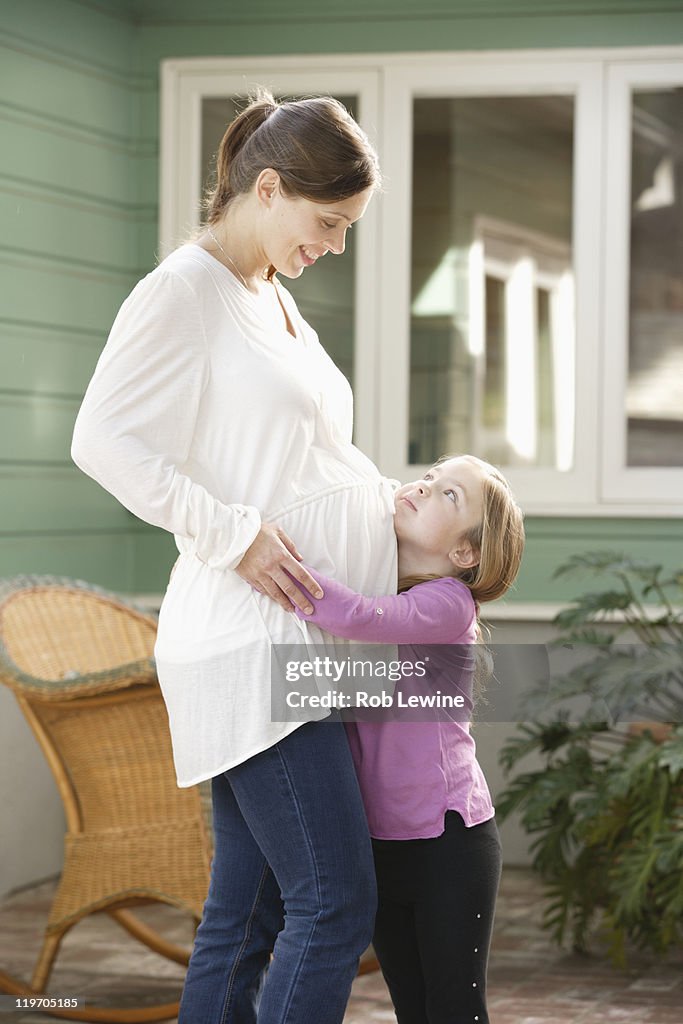 USA, California, Los Angeles, expectant mother embracing daughter (4-5)